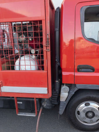 Red truck holding a tyre pressure control unit