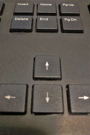 Arrow keys on a black colored computer keyboardの写真素材