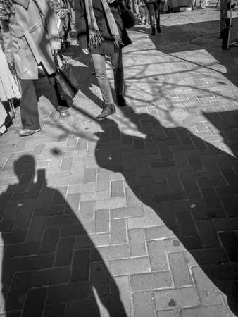 Selfie shadows on the street pavement in Auckland New Zealand during a bright sunny dayの写真素材