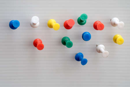 Colorful pins Embroidered on a white ground.
