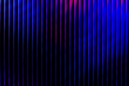 This captivating image showcases a series of illuminated vertical lines with a gradient of warm hues against a dark background, evoking a sense of modernity, technology, and sophistication ideal for contemporary design and digital themesの写真素材