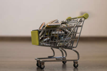 Small cart with sweets in the form of money in a round plan. A cart with sweets on the floor....