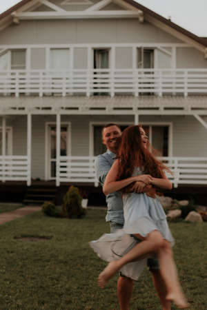 A young couple in love is having fun in the courtyard of the house. vertical photo. selective focusの写真素材