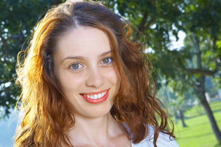 portrait of nice redhead girl in summer environmentの写真素材