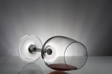 view of laying fragile wine glass on gray backgroundの写真素材