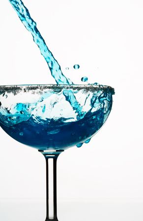 view of glass getting filled up with blue Curacao の写真素材