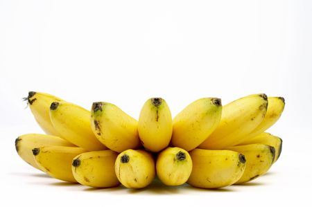 view of bunch of nice fresh delicious bananas on white sheetの写真素材