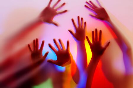 silhouette of hands on colorful back. Image may contain slight multicolor aberration as a part of design の写真素材