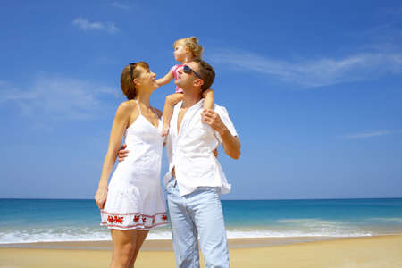 Portrait of young family having fun on the beachの写真素材