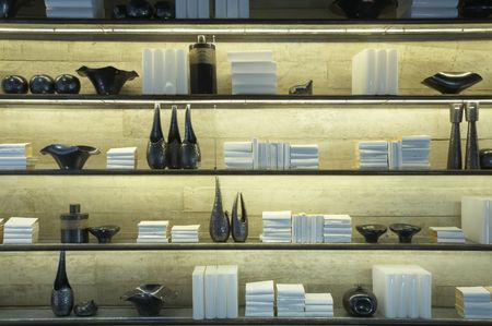 View of some shelves filled with books and decoration itemsの写真素材