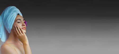 Portrait of young beautiful woman wearing white towel on head. Banner, lots of copy space.の写真素材