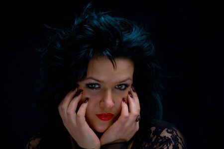 Low key Portrait of young woman coming out the darknessの写真素材