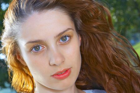 portrait of nice redhead girl in summer environmentの写真素材