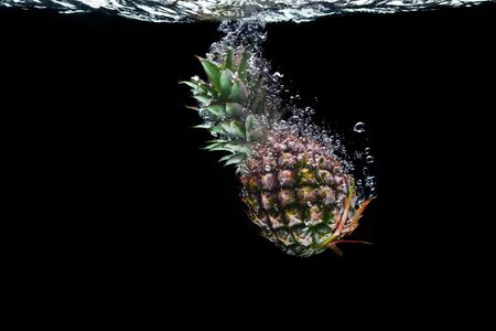 View of nice big pineapple getting through the waterの写真素材