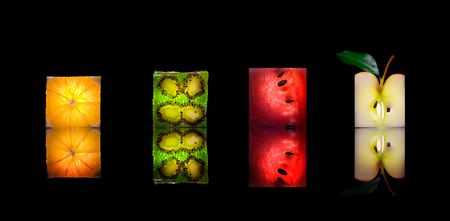 View of fresh fruit slices on black backの写真素材