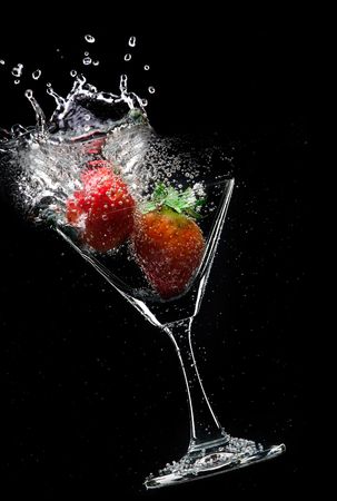view of  martini glass with strawberry on black backgroundの写真素材