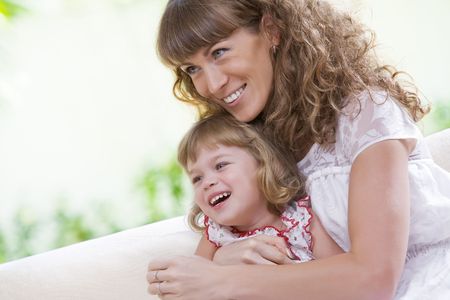 portrait of happy mother with daughter  having good time in summer environmentの写真素材