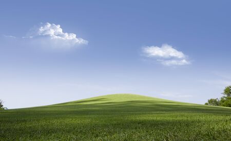 panoramic view of nice green hill on blue sky backgroundの写真素材