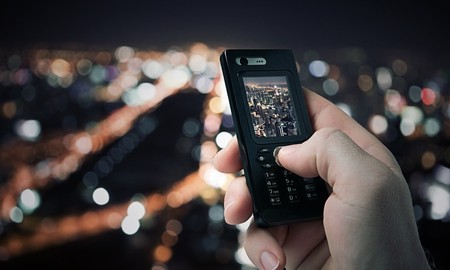 close up view of  mobile phone taking picture on color backの写真素材