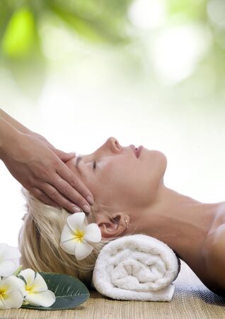 portrait of young beautiful woman in spa environmentの写真素材