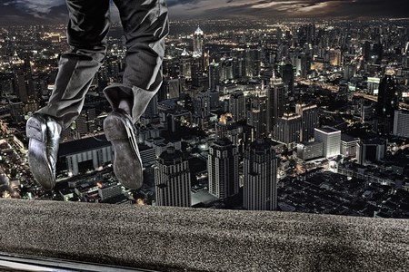 close up  fragment like view of a man jumping from the top of skyscraper の写真素材