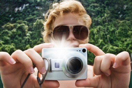Portrait of young nice woman taking photo in summer environmentの写真素材