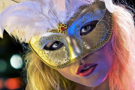 Close up portrait of young woman wearing mask on color back