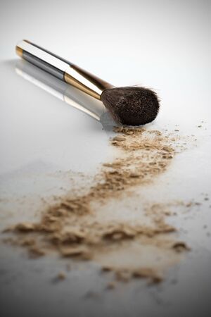 Close up view of face powder and brush on white back