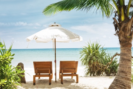 view of two chairs and  white umbrella on the beach の写真素材