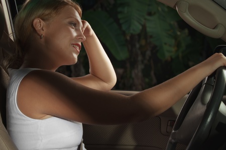 portrait of young beautiful woman sitting in the car