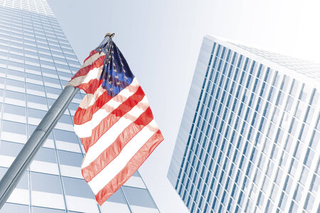 View of American flag on blue building backgroundの写真素材