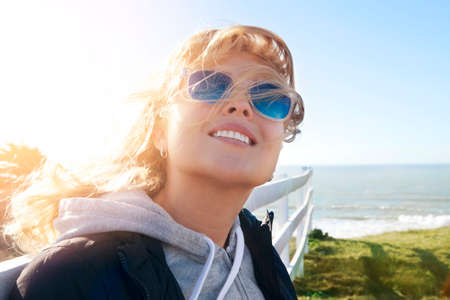 Portrait of young beautiful woman on winter outdoor background の写真素材