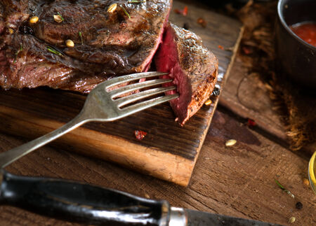 close up view on nice fresh steak on color backgroundの写真素材
