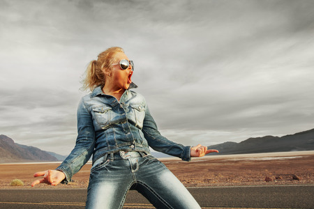 portrait of young beautiful girl in sunset road environmentの写真素材