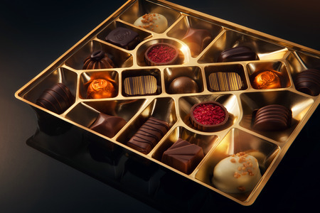 view of box of nice chocolate candies on black backgroundの写真素材