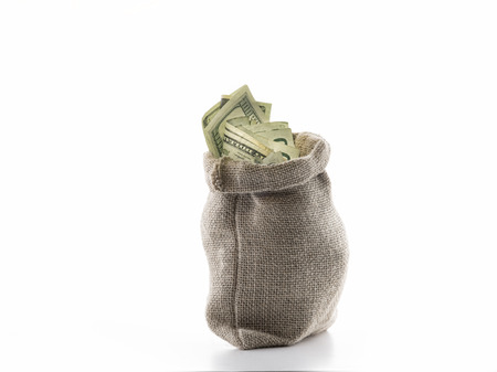 close up view of a bag full of cash money dollars bills in amountの写真素材