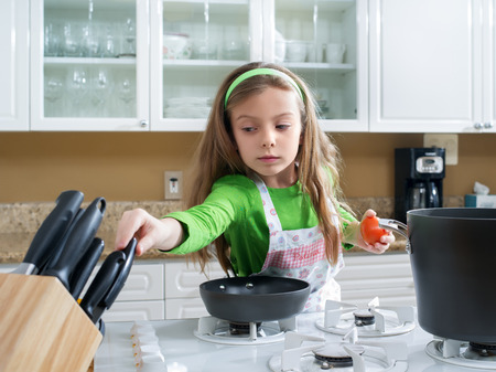 view of young beautiful girl cooking at the kitchenの写真素材