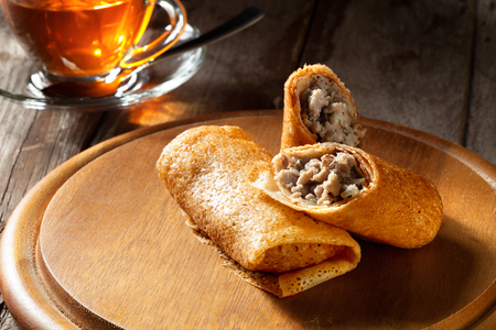 view of nice fresh hot crepes with grounded  meat  on color backgroundの写真素材