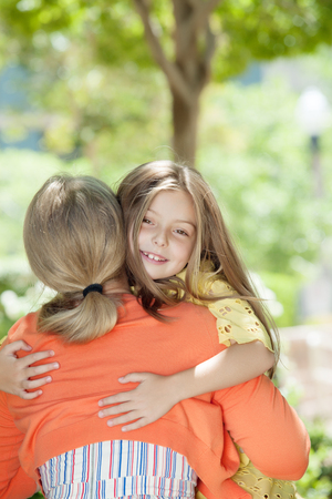 portrait of happy mother with daughter  having good time in summer environmentの写真素材
