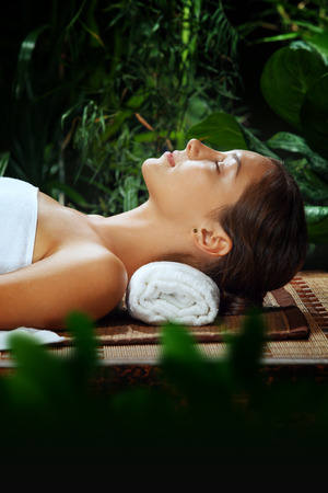 portrait of young beautiful woman relaxing in spa environmentの写真素材