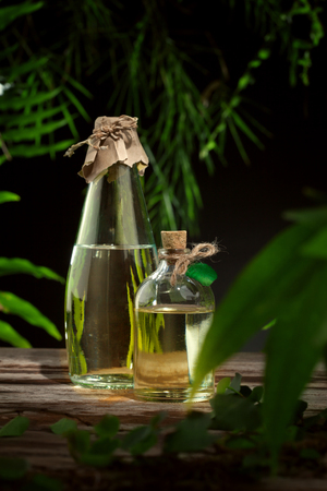close up view of nice small bottle with massage oil on color backの写真素材