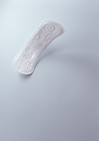 close up view of woman's sanitary pad on color backの写真素材