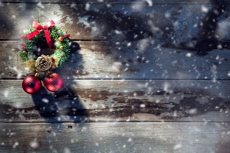 close up view of christmas tree toys and lights on wooden backの写真素材