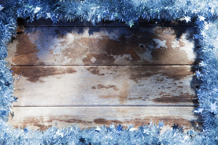 close up view of christmas tree garland on wooden backの写真素材