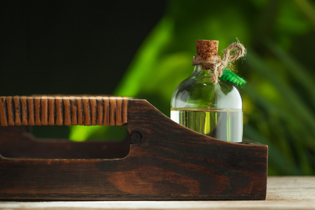 close up view of nice small bottle with massage oil on color backの写真素材