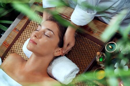portrait of young beautiful woman relaxing in spa environmentの写真素材
