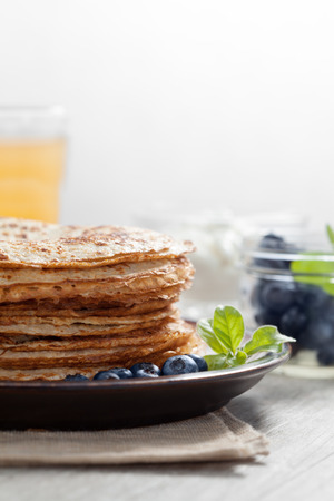 close up view of nice yummy crepes with berry on tableの写真素材