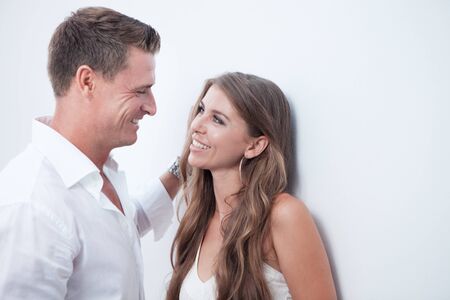 portrait of nice young couple on white wall backgroundの写真素材