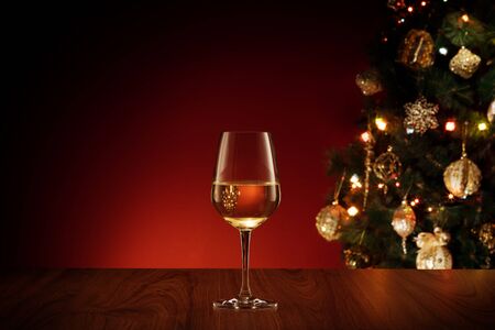 Close up view of glass with white sparkling wine on color backの写真素材