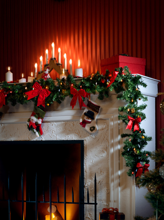 view of nice white christmas decorated fireplace  with fire  in itの写真素材